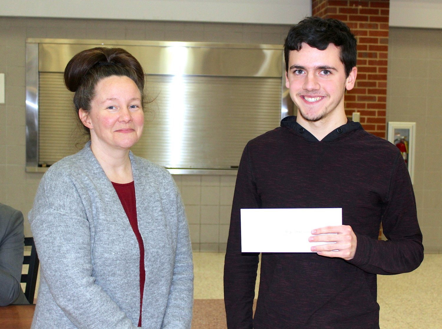 Foundations for Life Essay Contest winner Drake Hayes, right, accepts the grand prize from Character Counts! Board Member Anna Roth during an awards ceremony at Crawfordsville High School on Tuesday.
